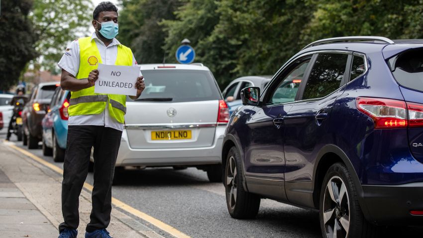 LONDON, ENGLAND - SEPTEMBER 25: A Shell garage employee holds a sign on the side of the road informing a queue of traffic that they do not have unleaded petrol on September 25, 2021 in Blackheath, London, United Kingdom. BP and Esso have announced that its ability to transport fuel from refineries to its branded petrol station forecourts is being impacted by the ongoing shortage of HGV drivers and as a result, it will be rationing deliveries to ensure continuity of supply. (Photo by Chris J Ratcliffe/Getty Images)